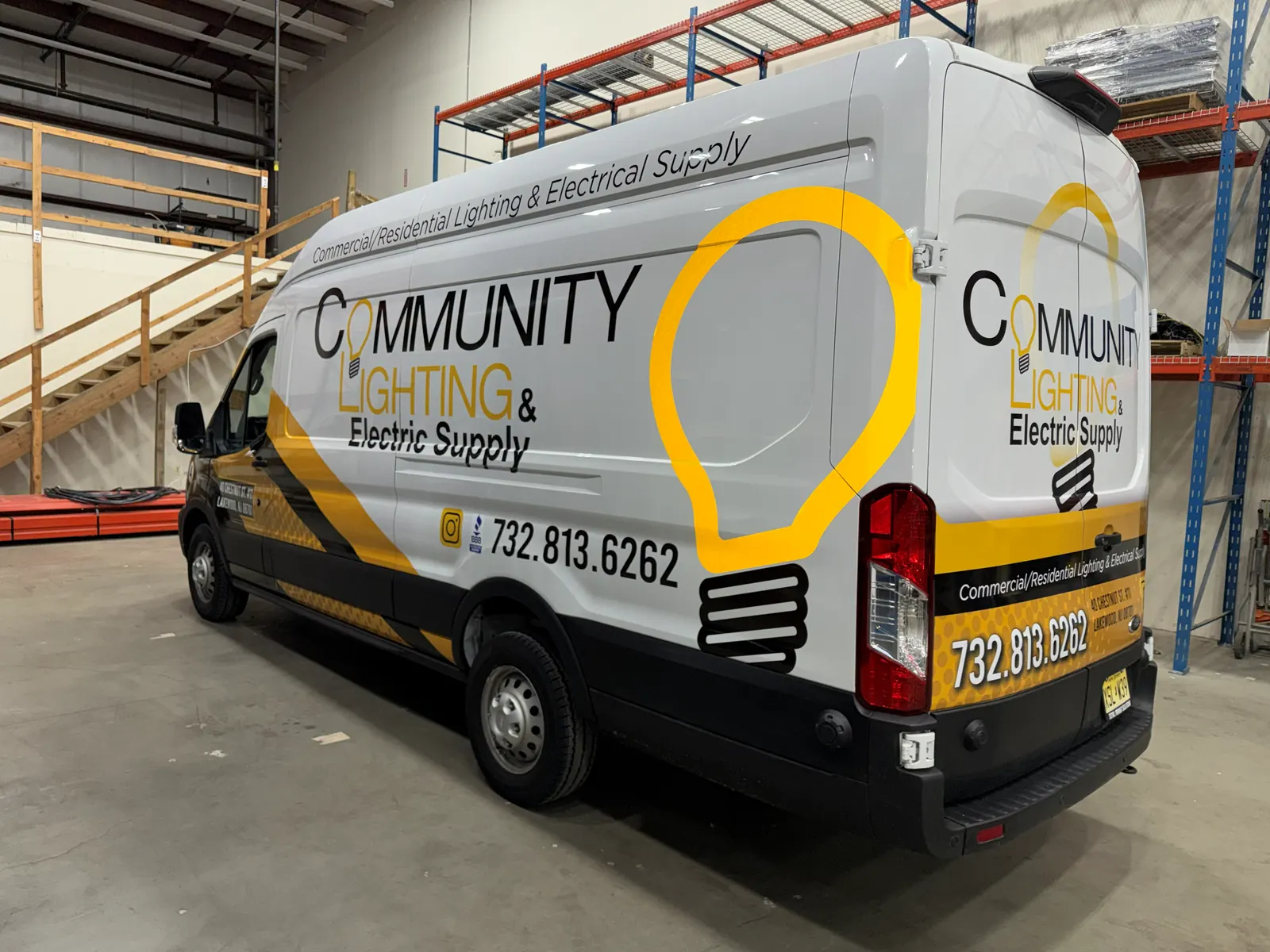 COMMUNITY LIGHTING & ELECTRIC SUPPLY partial wrap — rear three-quarter, in the shop