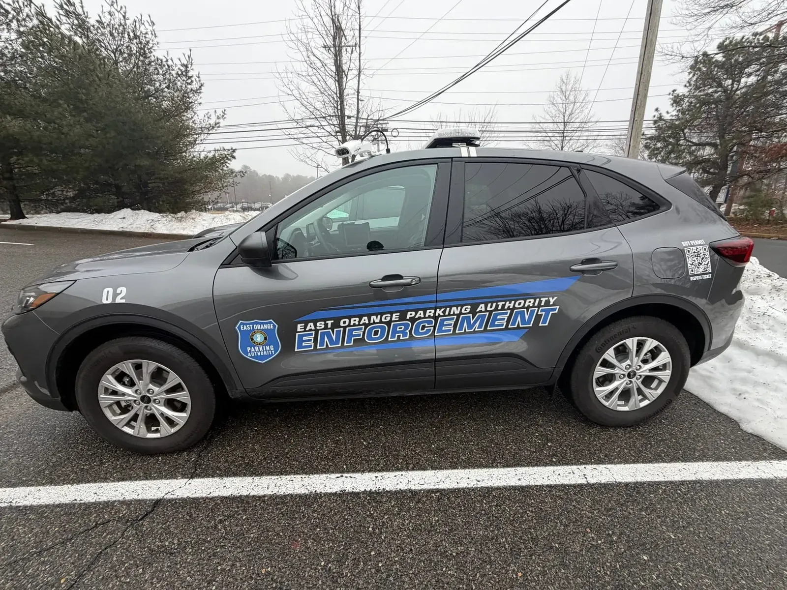 EAST ORANGE PARKING AUTHORITY stripes + lettering — driver side
