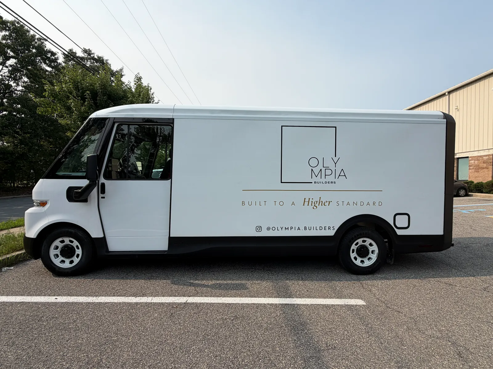 OLYMPIA BUILDERS lettering — driver side