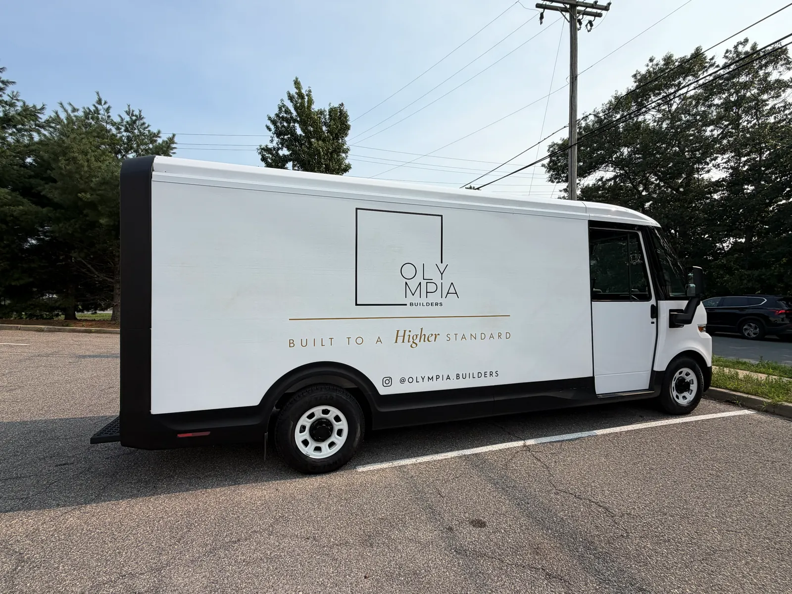 OLYMPIA BUILDERS lettering — passenger side
